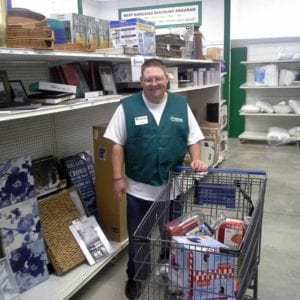 Happy adult with intellectual disability working at his new job.